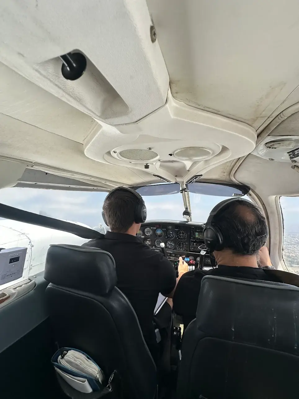 Students at Essence Flight School in Van Nuys Airport learning to fly in a Piper Archer cockpit